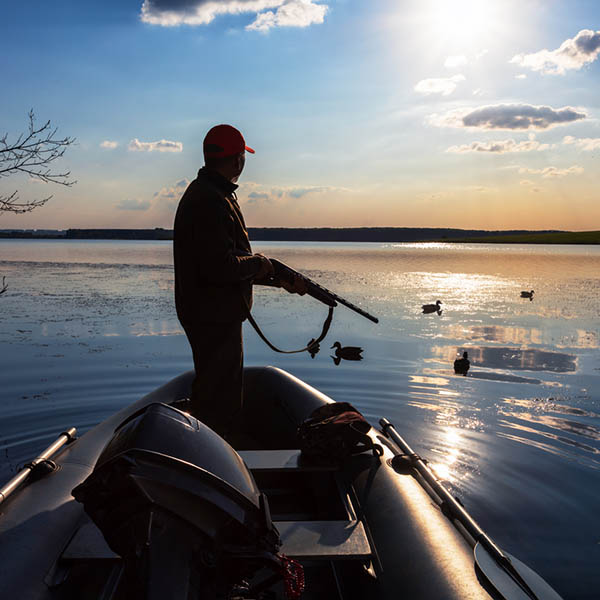 A duck hunter at sunset